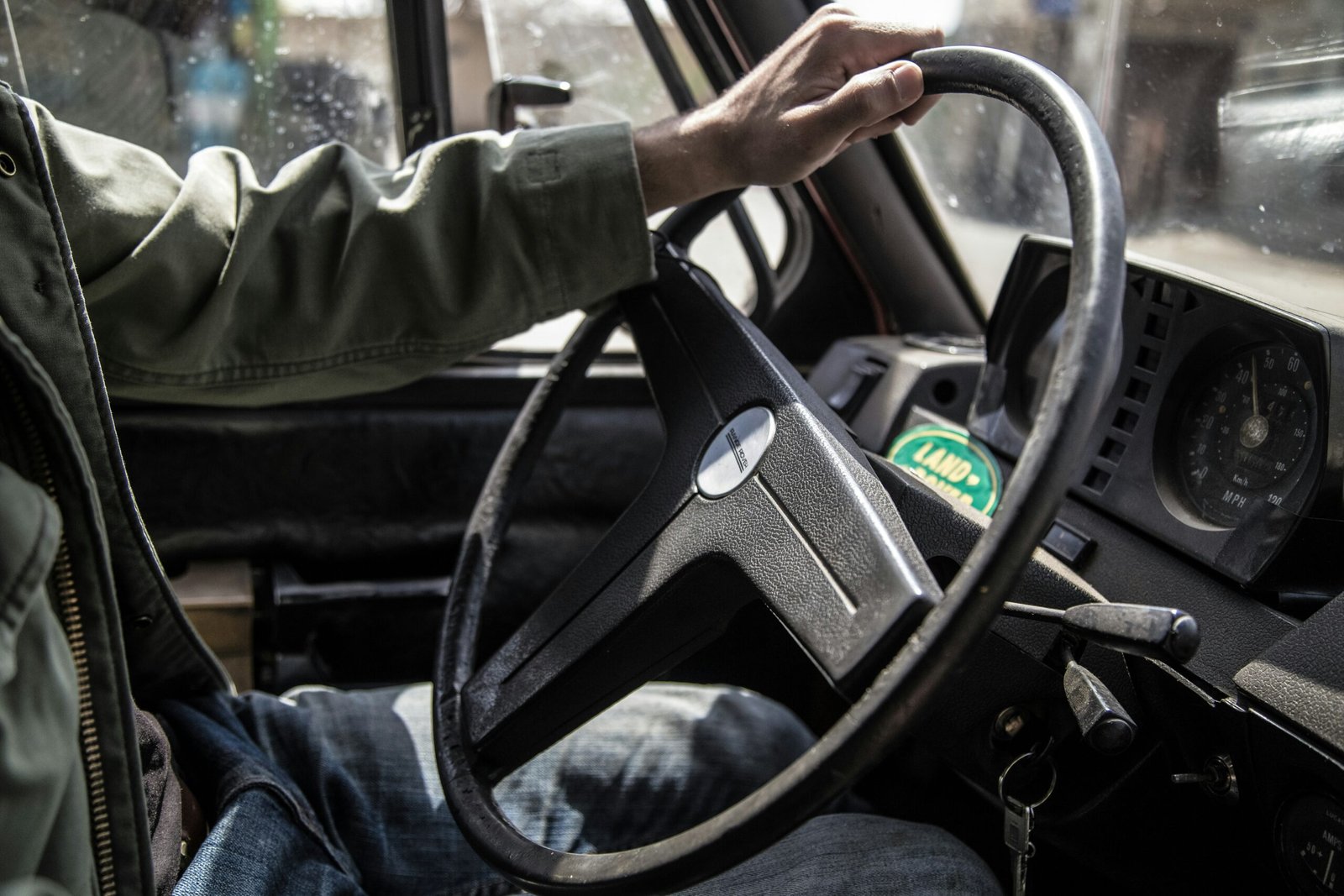 person holding black steering wheel